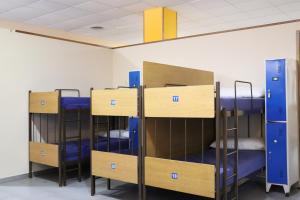 a row of bunk beds in a room at ALBERGUE DON QUIJOTE in Arzúa