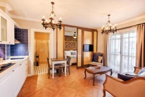 a kitchen and living room with a table and a dining room at Petite Boutique Hotel in Ildır