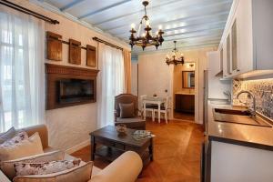 a kitchen and living room with a couch and a table at Petite Boutique Hotel in Ildır