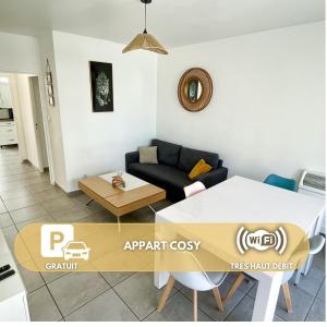 a living room with a couch and a table at Appart Cosy sur Salon de Provence in Salon-de-Provence