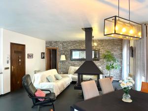 a living room with a couch and a fireplace at Alojamiento Turístico Casa Ela in L'Aldea