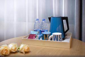 a box with bottles of water and cups on a table at Echarm Hotel - Beijing Road Pedestrian Street Sky Pier in Guangzhou
