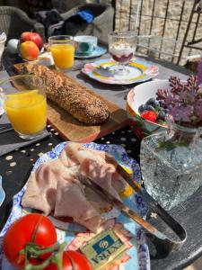 een tafel met borden met eten en drinken bij La Bastide de La Bogne in Vindrac-Alayrac