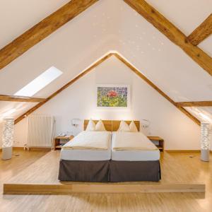 a bedroom with a bed in a attic at ODELYA Hotel & Naturgarten Basel City in Basel