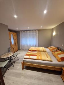 a bedroom with a large bed and a table at Ferienwohnung Bacharach in Bacharach