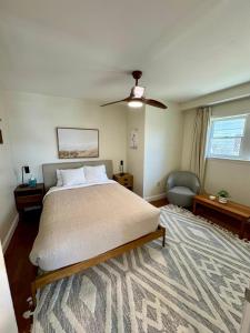a bedroom with a bed and a ceiling fan at Central Lake Placid Hideaway in Lake Placid