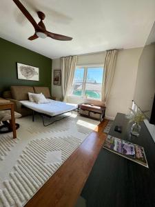 a living room with a bed and a couch at Central Lake Placid Hideaway in Lake Placid