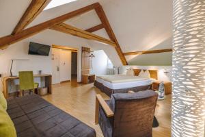 a bedroom with two beds and a desk in a room at ODELYA - Stadthotel im Park in Basel