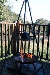a fire grill with a pot on top of it at Eisa Yurt in York