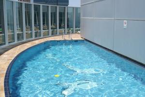 a swimming pool on top of a building at Studio Apartment - Cozy, Very Accessible and so near to Train Station in Dubai