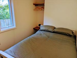a bed in a bedroom with a window at The Sunset "with private Hot tub" in Worth