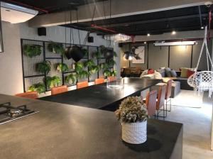 a kitchen with a table with plants on the wall at RioDowntown - Rede Nosso Cantinho in Rio de Janeiro