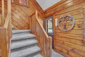 a staircase in a cabin with a wooden wall at Cabin in Long Pond Gameroom Pool Table in Long Pond