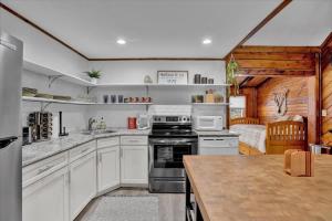 a kitchen with white cabinets and a stove top oven at Cabin in Long Pond Gameroom Pool Table in Long Pond +80 photos
