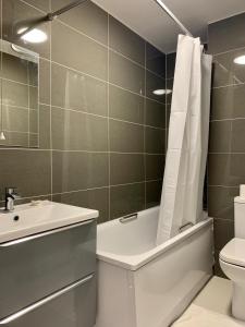 La salle de bains est pourvue d'une baignoire, d'un lavabo et de toilettes. dans l'établissement Chancery Lane Residenses, à Londres