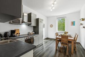 a kitchen with a table and chairs in a room at Elegant & Bright ~ Near Schalke 04 ~ Office ~ Free Parking! in Gelsenkirchen