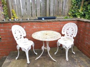 two chairs and a table and a table and two chairs at Jasmine Haus in Moortown
