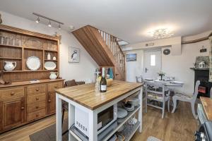 a kitchen with a table and a dining room at Penrhyn Cottage in Cemaes Bay