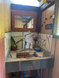 a bathroom with a sink and a mirror at Cafe Sabang Guest House in Sabang