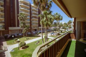 a view from the balcony of a building with palm trees at Sol & Mar apartment in Fuengirola