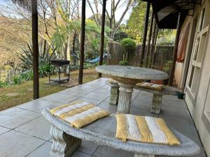 a stone table with two pillows on a patio at Sabie Self Catering Apartments in Sabie