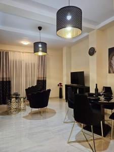 a living room with black chairs and a table at Merter Apartments in Kavadarci