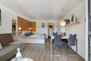 a living room with a bed and a table and chairs at Ferienappartement Magjar in Küssaberg