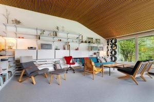 a living room with chairs and a table and shelves at Haus Erika in Alpirsbach