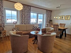 a living room with a couch and chairs and a table at Alpenhof Wängle in Reutte