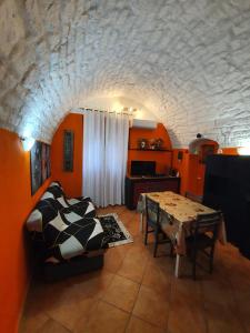 a living room with orange walls and a table at la casa antica in Sassari