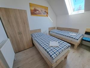 a room with two beds and a window at Apartmány Amália in Piešťany