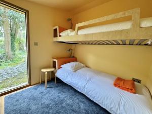 a bedroom with two bunk beds and a window at The BoatShed in Lymington