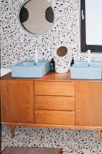 a bathroom with two sinks and a mirror at Adventure Camp Schnitzmühle in Viechtach
