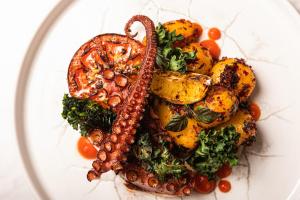 a plate of food with vegetables and other foods at Grand Poet Hotel and SPA by Semarah in Rīga