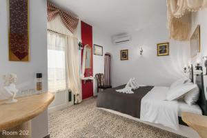 a bedroom with a bed and a red and white wall at Voreades in Tinos