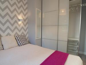 a bedroom with a bed with a purple blanket at K2182 New Cristal Grand-Tourist in Gdańsk