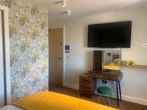 sypialnia z łóżkiem i telewizorem na ścianie w obiekcie STAG & THISTLE HOTEL AND RESTAURANT w mieście Fraserburgh