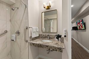 a bathroom with a sink and a mirror at Red Roof Inn Carson - Wilmington, CA in Wilmington
