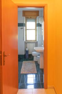 a bathroom with a sink and a toilet and a window at VILLA SOFIA in Montenero di Bisaccia
