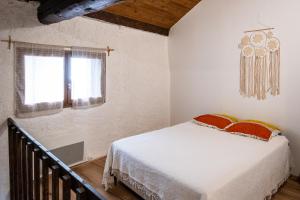 a bedroom with a bed and a window at Bol d'air à Mijanès in Mijanès