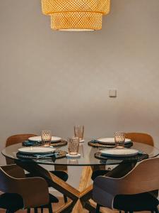 a dining room with a glass table and chairs at Beach Apartment Jelka in Supetar