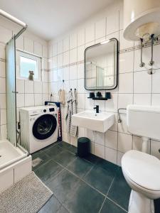 a bathroom with a sink and a washing machine at House Jelka in Supetar +16 photos