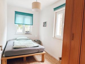 a bedroom with a bed and a window at House Jelka in Supetar