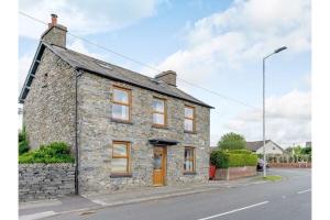 a stone house on the side of a street at luxury Farmhouse: Hot Tub & Garden in Soutergate