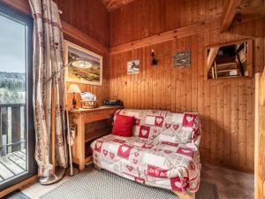 a room with a bed and a desk and a window at Chalet Les Gets, 2 pièces, 6 personnes - FR-1-671-139 in Les Gets