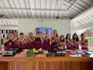 a group of people standing around a table at Anggrek Putih Homestay & Cooking Class in Senggigi