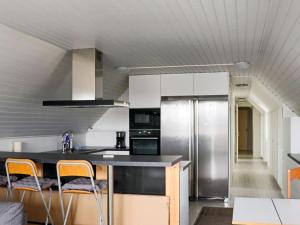 a kitchen with a counter and a refrigerator at Holiday home Halmstad XI in Halmstad