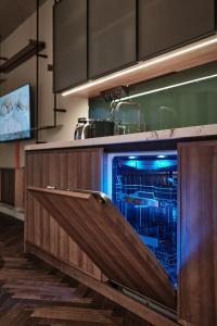 a kitchen with an open dishwasher in a kitchen at The Zipper Hotel und Apartments in Düsseldorf