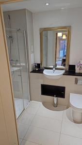 a bathroom with a sink and a shower and a toilet at Greenwich Glamorous 2-Bed Apartment in London