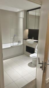 a bathroom with a sink and a toilet at Greenwich Glamorous 2-Bed Apartment in London